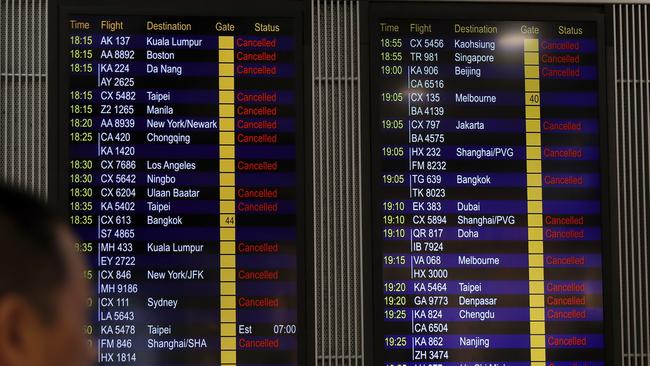 A man looks at the flight information board that shows outbound flights cancelled. Picture: AP