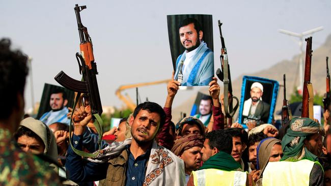 Supporters of Yemen's Houthi rebels raise portraits of their leader Abdul Malik Al-Houthi during rally in the capital Sanaa.