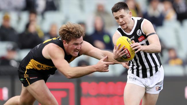 Glenelg’s Will Gould chases Port Adelaide’s Sam Davidson in the second semi-final. Picture SARAH REED