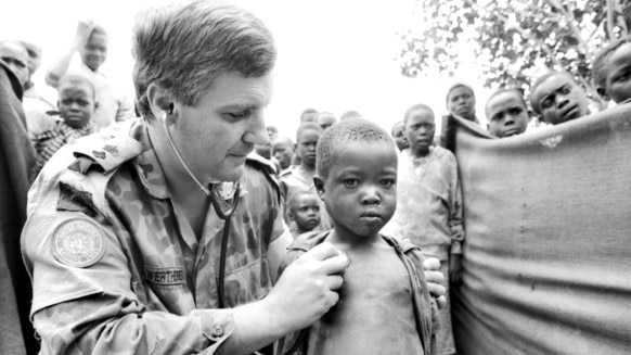 08-11-94 - Lieutenant Colonel (Lt Col) Michael Wertheimer, Commanding Officer of Tasmania's 10th Field Ambulance based in Hobart, serving with the Australian Medical Support Force in Rwanda as the General Surgeon, examines a young local child at Rwanda's largest displaced persons camp. Supplied: Australian War Memorial.