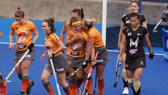 Britt Wilkinson of the Brisbane Blaze is congratulated by her teammates after scoring a goal during the Women's Hockey One Grand Fina. (AAP Image/Scott Barbour)