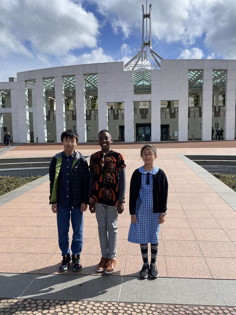 Zach Cheng, Ozi Egesi and Joanne Lee outside Parliament House in Canberra. The spelling champs rose to the top from more than 61,000 students who signed up for the 2022 Prime Minister's Spelling Bee.