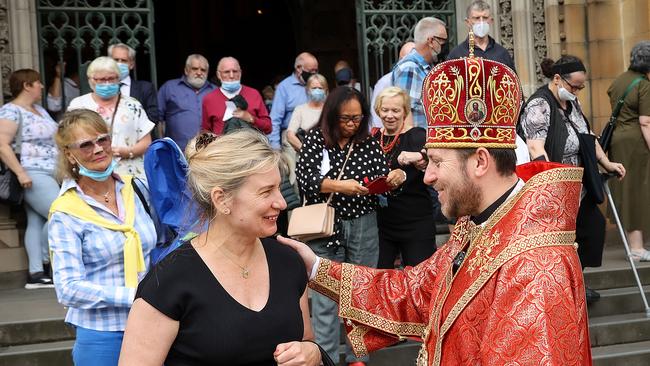 Ukrainian Bishop Mykola Bychok greets churchgoers outside St Patrick’s Cathedra. Picture: Ian Currie