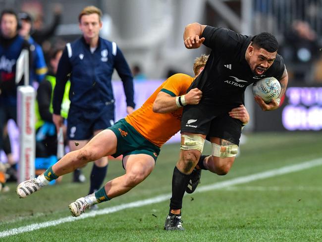 New Zealand's Ardie Savea (R) is tackled by Australia's Tate McDermott. Picture: Sanka Vidanagama / AFP.