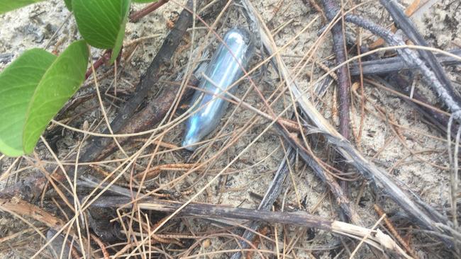 Nitrous oxide canisters or nangs, found on the sand dunes just metres away from a hotel where a schoolie plunged to his death from a balcony after allegedly inhaling nitrous oxide. Picture: Nic McElroy