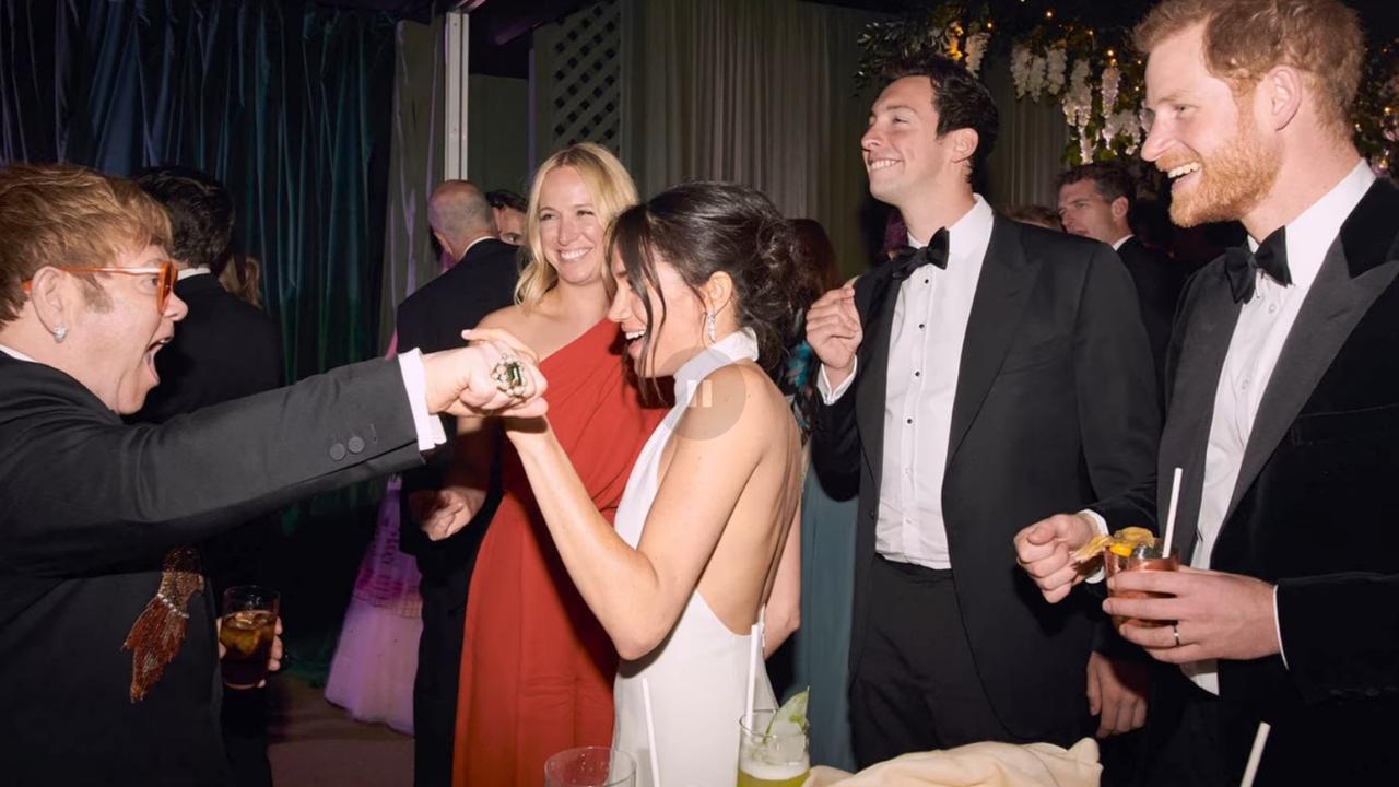 The couple celebrate with Elton John at their wedding. Picture: Netflix