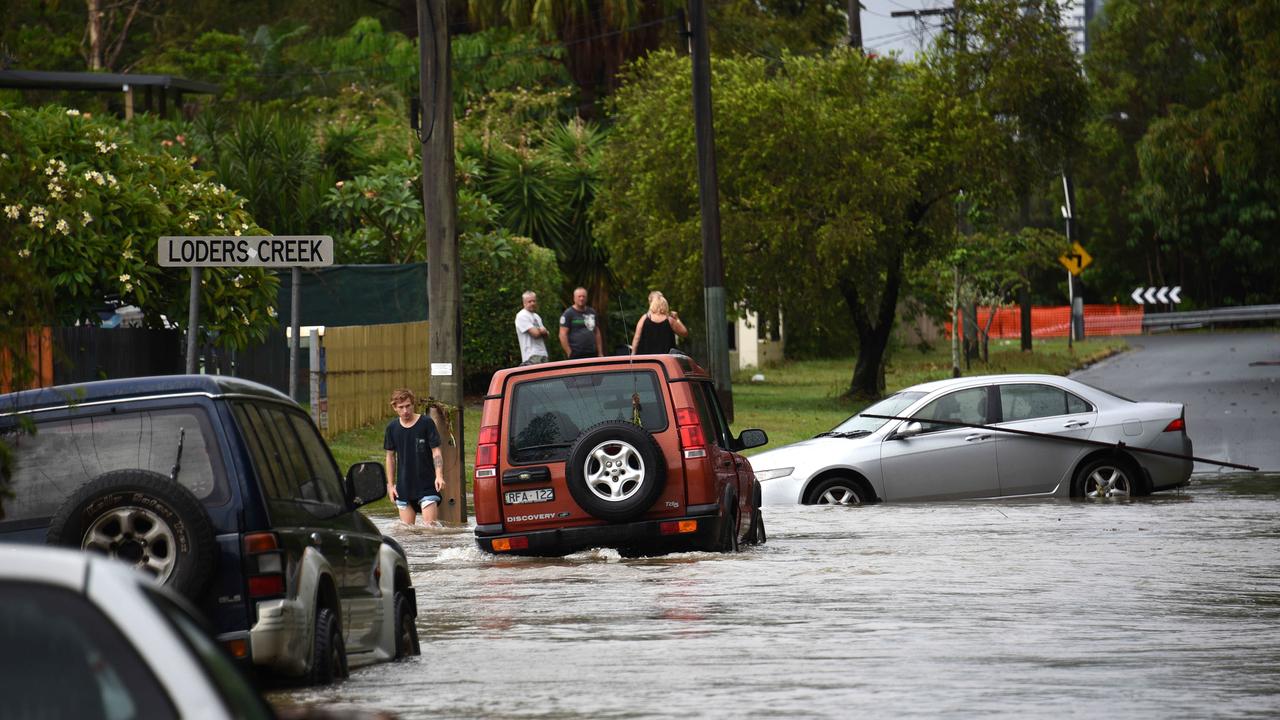 Cars stuck in waters at Baratta St, Southport after Loders Creed flooded. Picture: Steve Holland