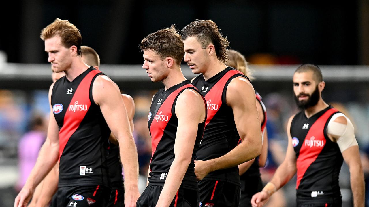 The Essendon players look dejected after losing the round 16 AFL match against the Geelong Cats.