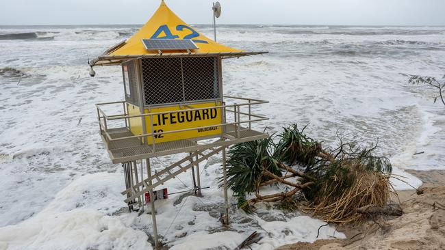 Meanwhile in Queensland ... A lifeguard post and a collapsed tree on the eroded beach shore on at the Southport spit on the Gold Coast. Picture: Getty Images