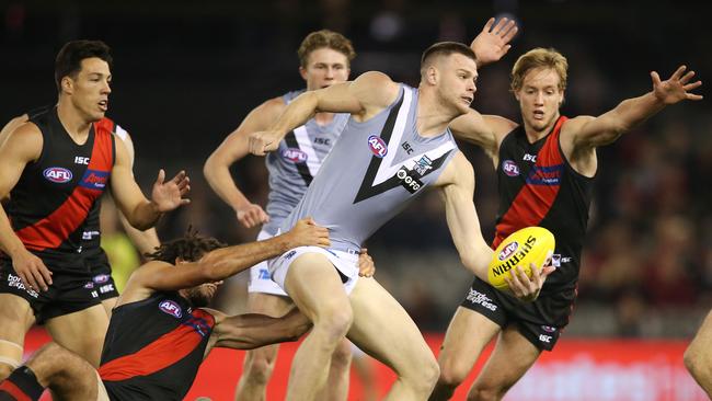 Peter Ladhams of the Power handballs out of a pack against Essendon. Picture: Michael Klein