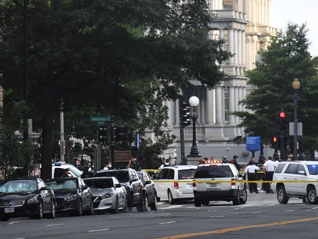 Police cars block the entrance to Pennsylvania Avenue near the White House shortly after Secret Service guards shot a person who was apparently armed. Picture: AFP