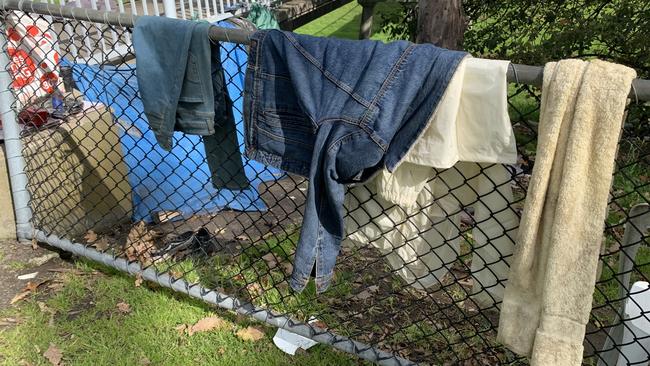 Clothes hanging off a fence at a homeless camp near Shepley Oval in Dandenong.