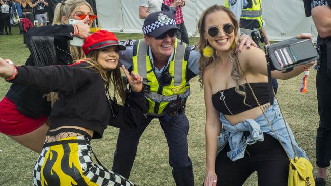 Police pose with Groovin the Moo festival patrons. Picture: Sean Davey.