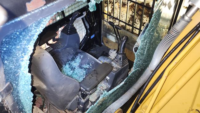 Activists smashed excavator cab window