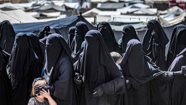 Detainees queue to receive humanitarian aid packages at the al-Hol camp, which holds relatives of suspected Islamic State fighters, and where a woman was beheaded at the time The Australian was in Syria last month.