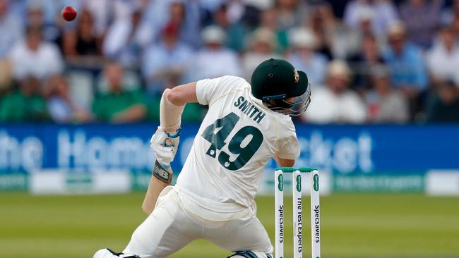 Steve Smith is rocked by the Jofra Archer bouncer in the second Test. Smith doesn’t wear a stem guard on the back of his helmet, saying it makes him feel claustrophobic. Picture: AFP