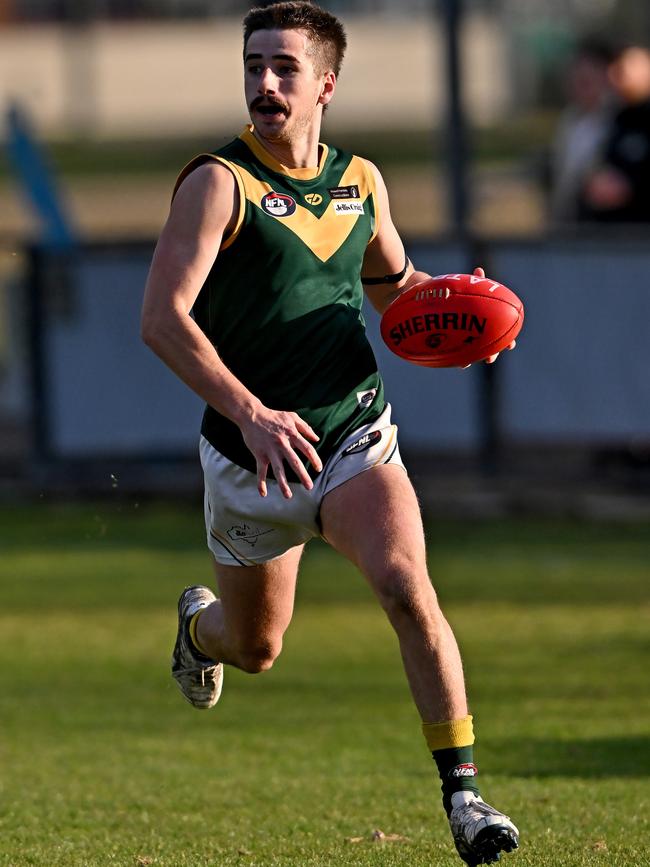 NFL: Old Eltham Collegians’ Ben Cox on the run. Picture: Andy Brownbill