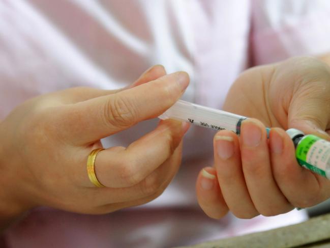 CORRECTION - (FILES) This file picture taken on July 24, 2018 shows a nurse preparing a vaccination shot at the local disease control and prevention center in Jiujiang in China's central Jiangxi province. - In China, multinational pharmaceutical companies have a bright future ahead of them. But they are faced with a local industry no longer content to produce generic medicines and are themselves betting on high quality and innovation. (Photo by STR / AFP) / - China OUT / TO GO WITH STORY by Etienne BALMER / “The erroneous mention[s] appearing in the metadata of this photo by STR has been modified in AFP systems in the following manner: [adding in restriction of CHINA OUT]. Please immediately remove the erroneous mention[s] from all your online services and delete it (them) from your servers. If you have been authorized by AFP to distribute it (them) to third parties, please ensure that the same actions are carried out by them. Failure to promptly comply with these instructions will entail liability on your part for any continued or post notification usage. Therefore we thank you very much for all your attention and prompt action. We are sorry for the inconvenience this notification may cause and remain at your disposal for any further information you may require.”