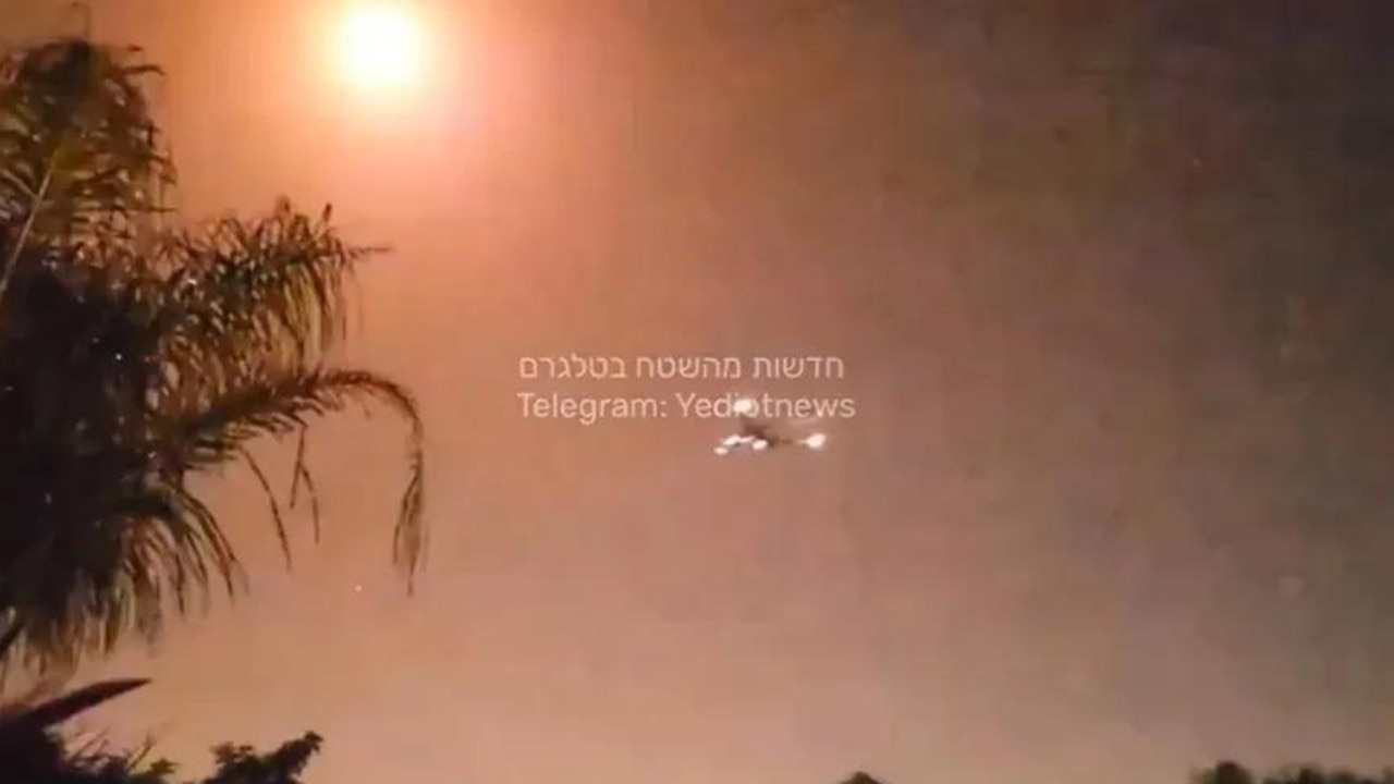 The plane can be seen dangerously close to a bright explosion in the sky above it, thought to have been caused by Israel's Iron Dome defence system. Picture: Telegram/Yediotnews