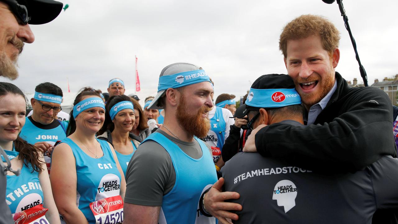 Prince Harry greets runners representing the charity Heads Together before officially starting 2017 London Marathon. Picture: Luke Macgregor/AFP