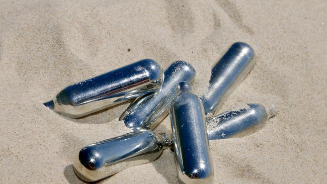 Canisters of ­nitrous oxide gas — also known as nangs or bulbs - found on the beach at Surers Paradise, where NSW teen Hamish Bidgood plunged to his death at the 2018 Schoolies. Photo: Nathan Richter