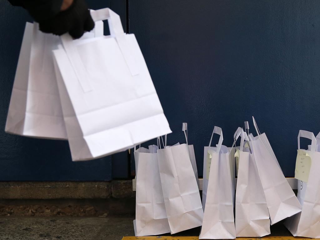 Bikeworks cycling instructor Jelil Adebiyi collects COVID-19 testing kits from the Royal London Hospital. Picture: AFP