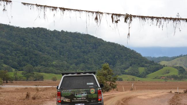 Debris on a powerline shows how high the flood was at Daintree Village. Picture: Bronwyn Farr