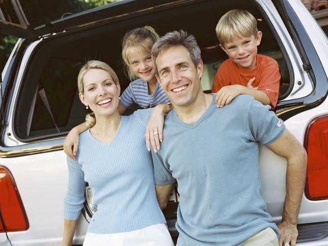 Family standing by a car