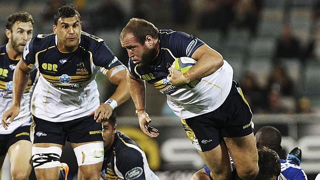 CANBERRA, AUSTRALIA - MARCH 22: Ben Alexander of the Brumbies is tackled during the round six Super Rugby match between the Brumbies and the Stormers at Canberra Stadium on March 22, 2014 in Canberra, Australia. (Photo by Stefan Postles/Getty Images)