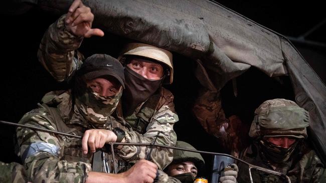 Wagner Group members look out from a military vehicle in Rostov-on-Don.