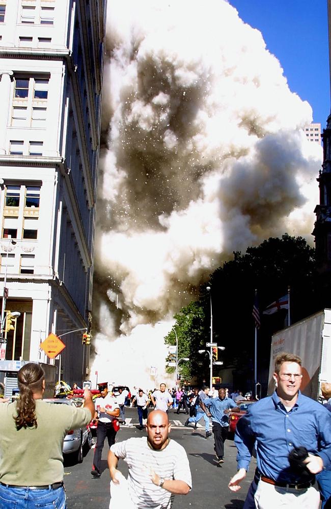 Pedestrians running from the scene as one of the World Trade Center towers collapses in New York City. Picture: Doug Kanter/AFP