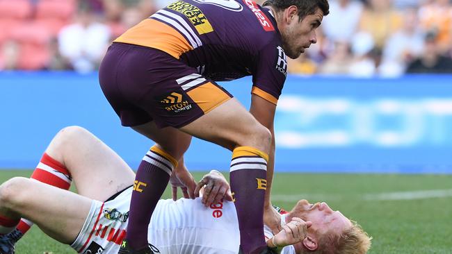 Andrew McCullough keeps an eye on a prostrate Graham. (AAP Image/Dave Hunt)