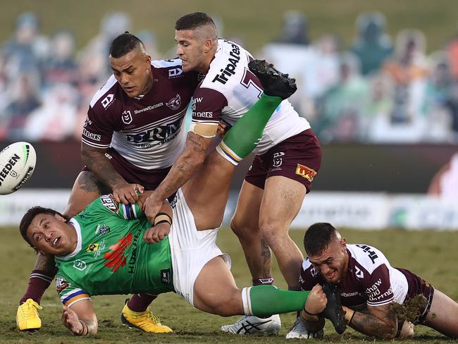 Lone mullet Josh Papalii of the Raiders is tackled by faded Manly Sea Eagles. Picture: Getty