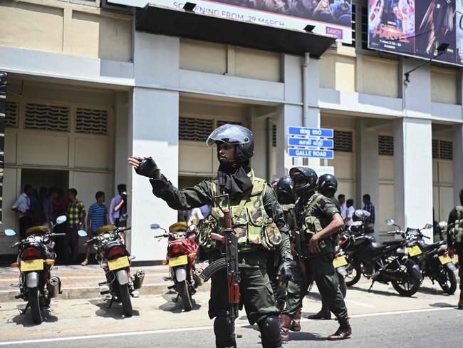 Security personnel stand guard after a controlled explosion in front of a movie theatre in Colombo. Picture: AFP 