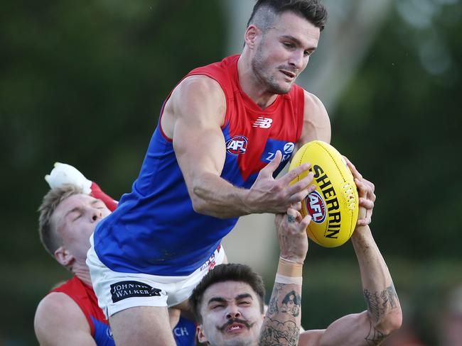 Joel Smith flies over Richmond’s Oleg Markov. Picture: Michael Klein