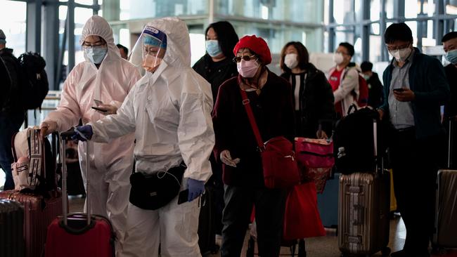 Passengers wearing face masks queue to board a Beijing-bound train at the Wuhan railway station in Wuhan in China's central Hubei province early on April 15, 2020. Picture: Noel Celis/AFP