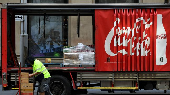 A worker unloads Coca-Cola Amatil (CCA) products outside the Australian Stock Exchange (ASX) in Sydney. Picture: NCA NewsWire/Joel Carrett