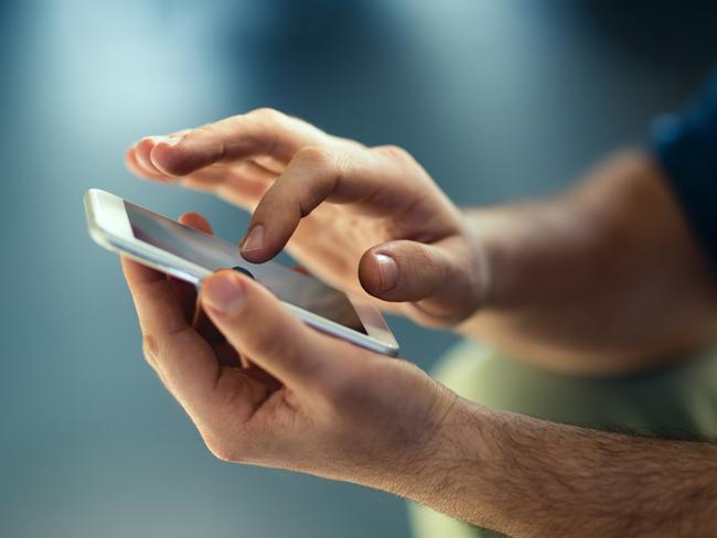 Generic Male hands typing on smartphone. Picture: Istock