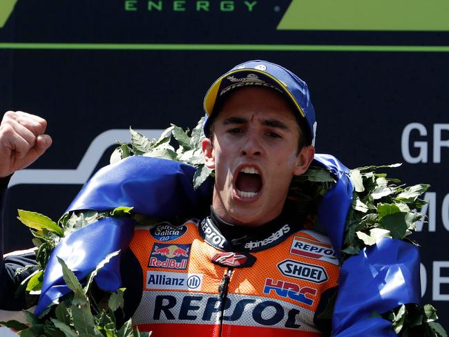 Marc Marquez shows his approval of his victory on the podium. Picture: AFP