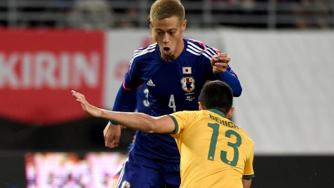 OSAKA, JAPAN - NOVEMBER 18: Keisuke Honda of Japan tests Aziz Behich of Australia during the international friendly match between Japan and Australia at Nagai Stadium on November 18, 2014 in Osaka, Japan. (Photo by Kaz Photography/Getty Images)