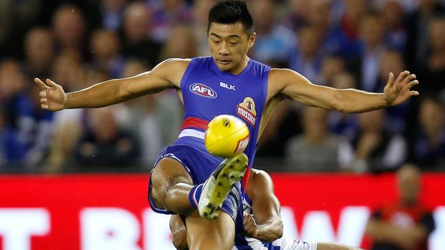 Lin Jong gets a kick away against North Melbourne.