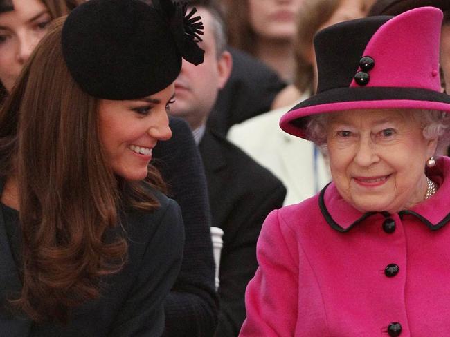 Catherine, The Duchess of Cambridge (L) and Queen Elizabeth II watch a fashion show at De Montfort University in Leicester, 08/03/2012.