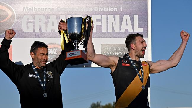 Heidelberg coach Vinny Dattoli and captain Sam Gilmore lift the premiership cup. Picture: Andy Brownbill