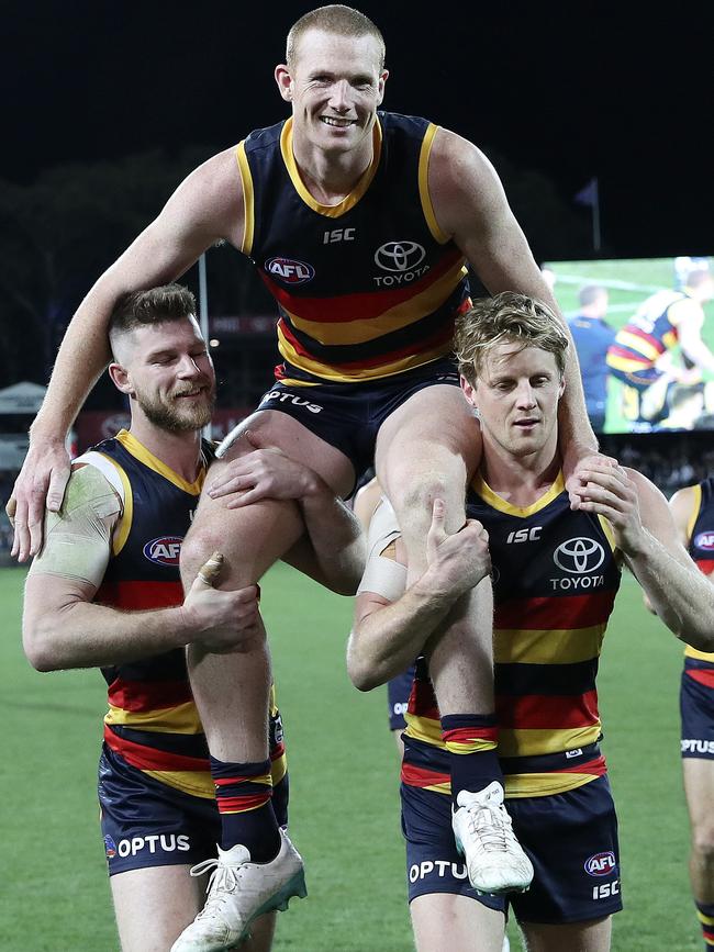 Sam Jacobs is chaired off Adelaide Oval by teammates Bryce Gibbs (left) and Rory Sloane following his 200th game in round 22. Picture: SARAH REED.