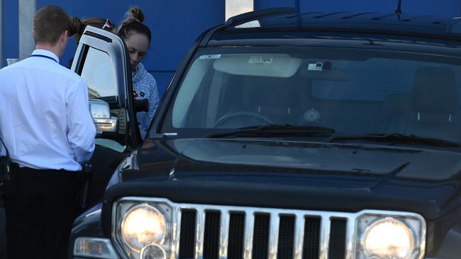 Detectives and forensic have a quick look inside a car at the scene of Monday’s fatal shooting. Picture: Nicole Garmston