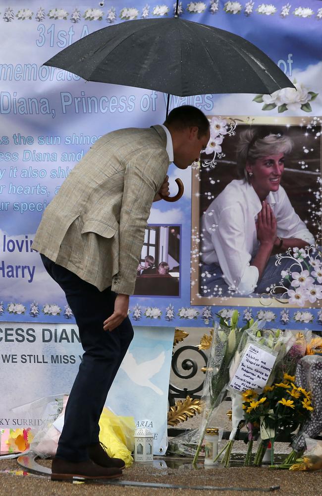 Britain's Prince William, Duke of Cambridge looks at tributes left by members of the public at one of the entrances of Kensington Palace to mark the coming 20th anniversary of the death of Diana. Picture: AFP