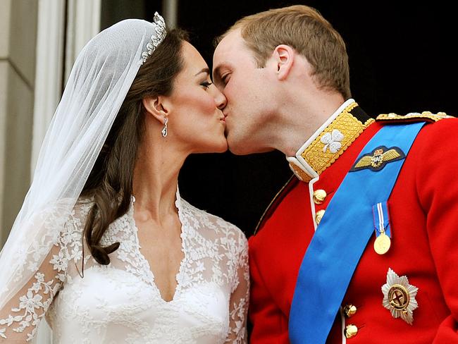 (FILES) In this file photo taken on April 29, 2011 Britain's Prince William and his wife Kate, Duchess of Cambridge, kiss on the balcony of Buckingham Palace in London, following their wedding at Westminster Abbey. Britain has long entranced the world with its spectacular royal weddings, occasions of glittering pageantry and glamour that feed into a fascination with the monarchy. / AFP PHOTO / POOL / JOHN STILLWELL