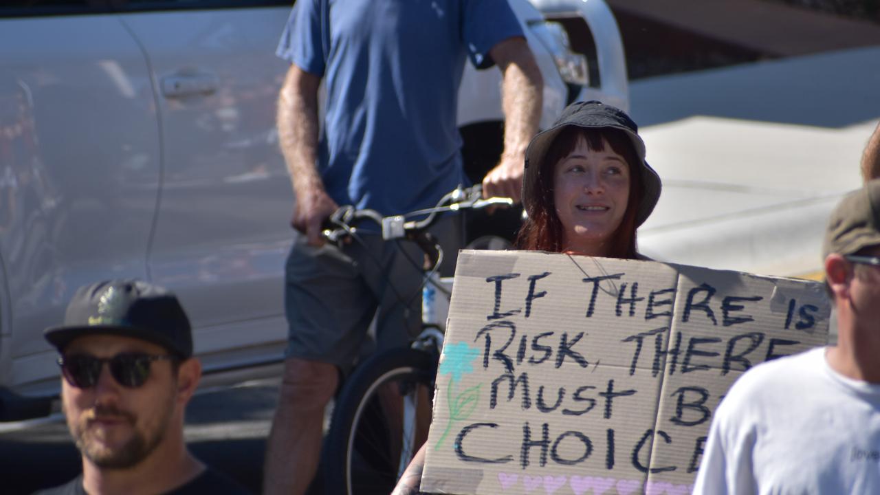 A sign reads ‘If there is risk there must be choice.’. Photo: Liana Walker