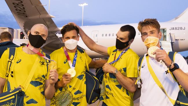 Gold medallist rowers (L-R) Spencer Turrin, Alexander Hill, Alexander Purnell and Jack Hargreaves hold up their medals after landing in Sydney from the Tokyo 2020 Olympic Games. Picture: Jenny Evans/Getty Images