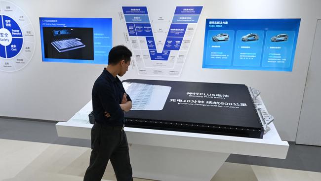 A visitor looks at a Shenxing Plus battery pack for electric vehicles in the showroom at the headquarters of Chinese EV battery maker CATL (Contemporary Amperex Technology Co., Limited) in southeast China. Picture: Greg Baker / AFP